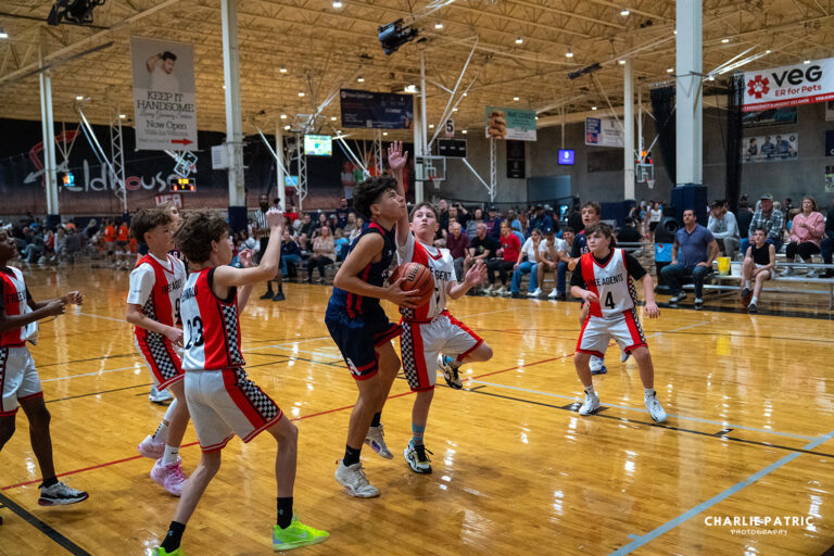 Youth basketball players compete on a court during a Frisco sports event.